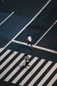 High angle view of people crossing road