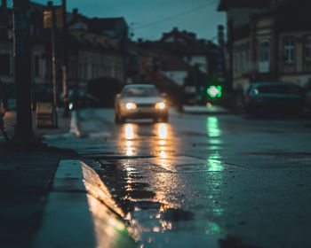 Cars on city street during rainy season