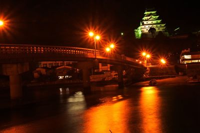 Illuminated bridge at night