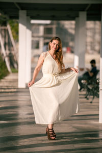 Young woman with umbrella walking outdoors