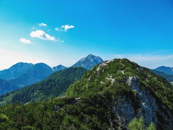 Scenic view of mountains against blue sky