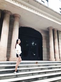 Full length of woman on staircase in building