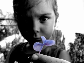 Close-up of girl holding flower