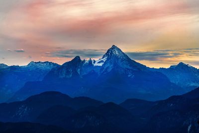 Scenic view of snowcapped mountains against sky during sunset