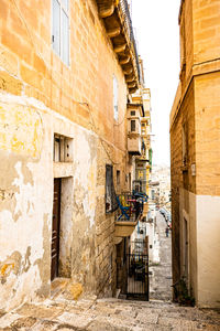 Ancient traditional houses in a narrow street in valletta, malta