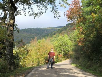 Rear view of woman riding bicycle on road