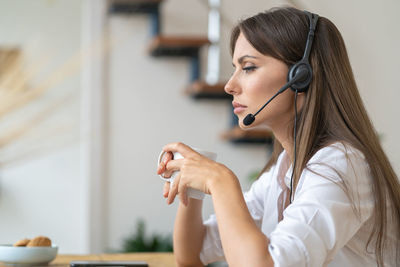 Side view of businesswoman working in office