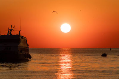 Scenic view of sea against orange sky