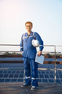 Portrait of young man standing against clear sky