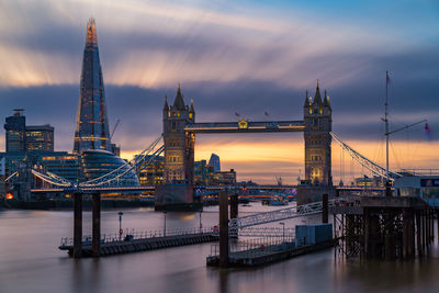 View of bridge over river against cloudy sky