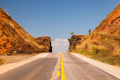 Empty road against blue sky