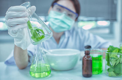 Close-up of female scientist experimenting in laboratory