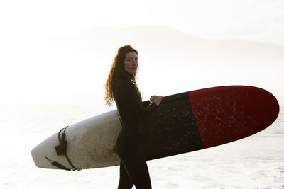 Beautiful, fit surfer girl in the pacific northwest