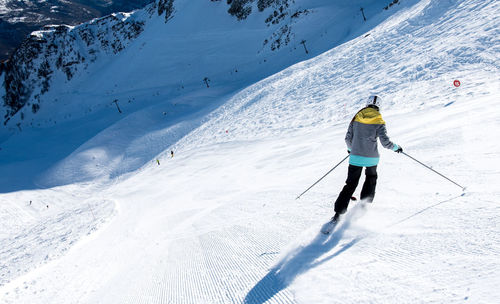 High angle view of person skiing on snowcapped mountain