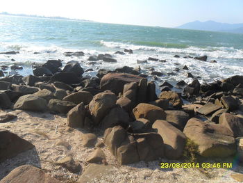 Rocks on beach against sky