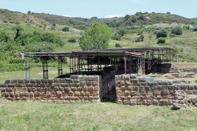 Built structure on landscape against the sky