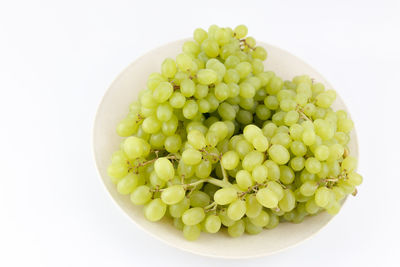 Close-up of fruits in bowl against white background