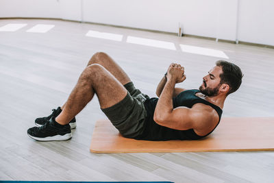 Full length of young man lying on floor