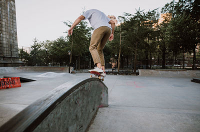 Full length of man skateboarding on skateboard park