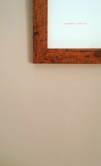 Cropped image of picture frame with text mounted on wall