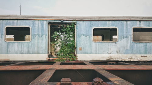 Exterior of abandoned train against sky