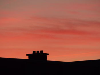 Silhouette building against sky during sunset