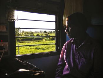 Thoughtful man sitting in train