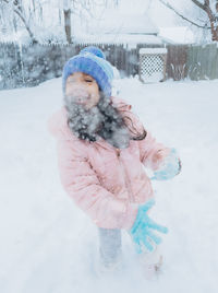 Portrait of young woman in snow