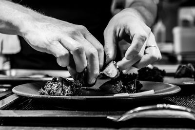 Close-up of person preparing food on table