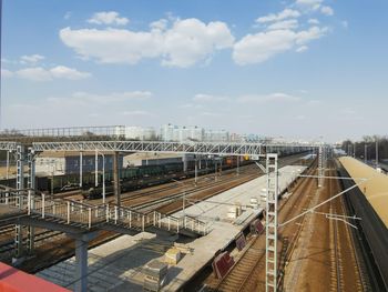 Railroad tracks in city against sky