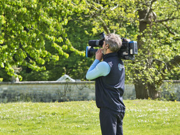 Full length of man photographing