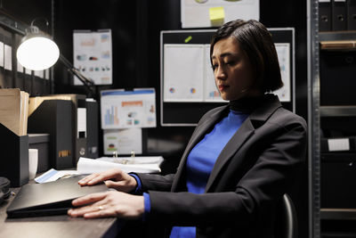 Portrait of businesswoman using laptop at office