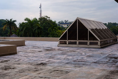 View of swimming pool by building against sky