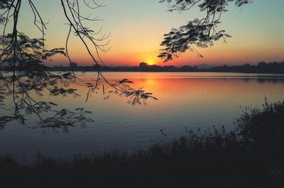 Scenic view of lake against sky during sunset