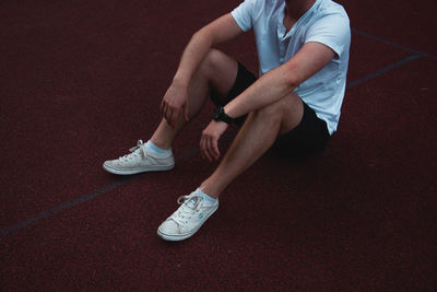 Low section of man sitting on floor