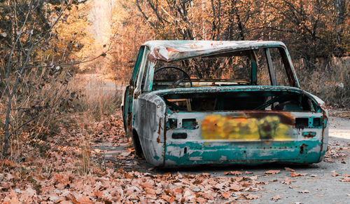 Abandoned car parked in forest