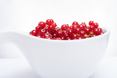 Close-up of strawberries in bowl against white background