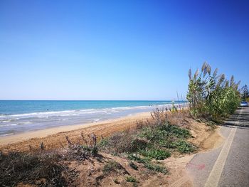 Scenic view of sea against clear blue sky