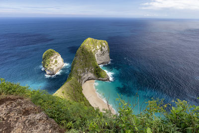 High angle view of rocks by sea against sky