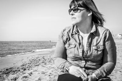 Mid adult man sitting on beach