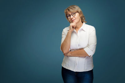 Portrait of mid adult man against blue background