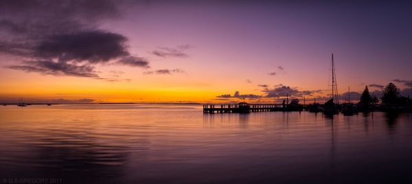 Scenic view of sea against romantic sky at sunset