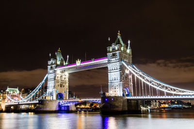 Low angle view of suspension bridge at night