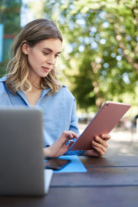 Young woman using laptop at table