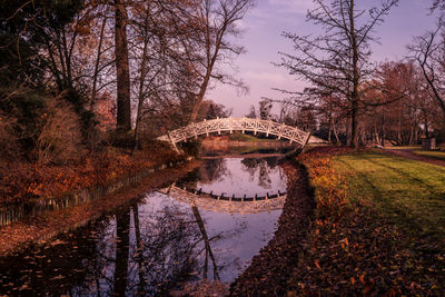 Arch bridge over canal against sky during autumn