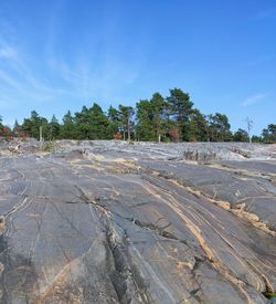 Scenic view of land against blue sky