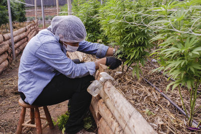 Side view of man working at farm