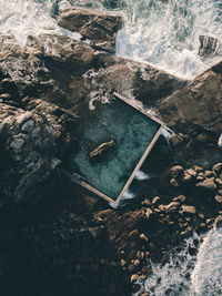 High angle view of rock formations by sea