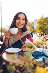 Portrait of young woman drinking coffee in cafe person