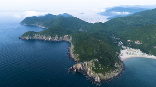 High angle view of sea and mountains against sky